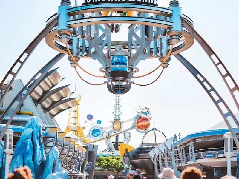 Astro Orbiter attraction and Tomorrowland structures with visitors below